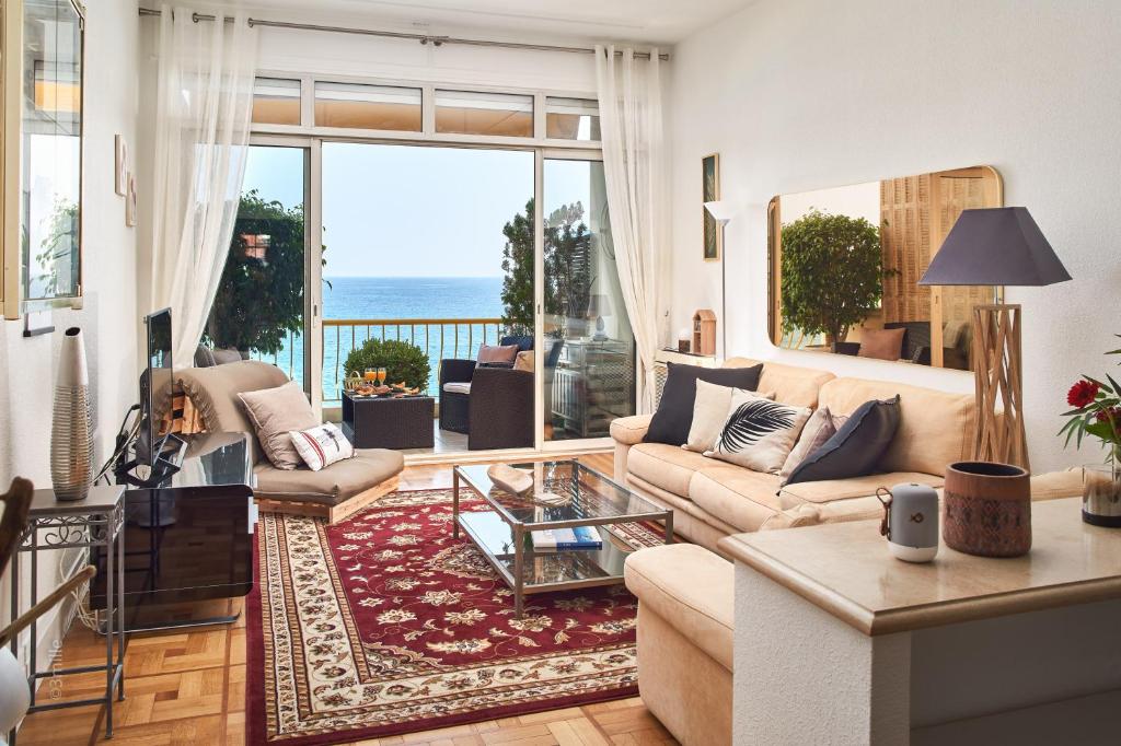 a living room with a view of the ocean at Sunlight Properties - "Maryland " - Sea Front in Nice