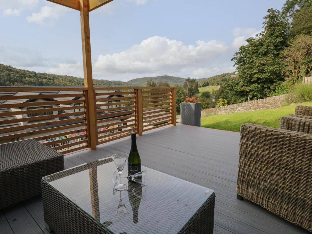 a bottle of wine sitting on a table on a deck at Bishop Fell in Newby Bridge