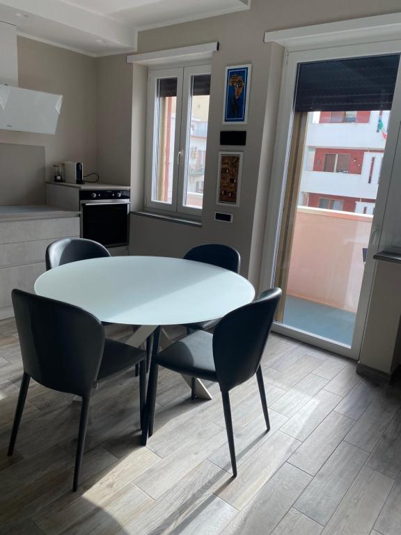 a dining room with a white table and chairs at Casa Stefy in Bari