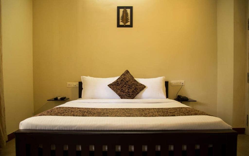 Postel nebo postele na pokoji v ubytování Nambiars Premium Heritage Hotel