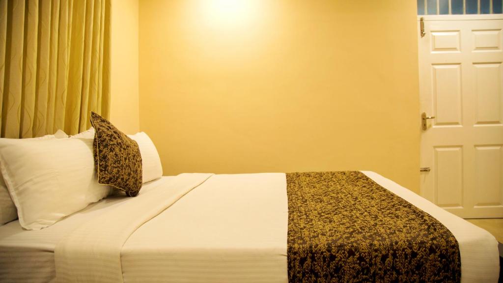 Postel nebo postele na pokoji v ubytování Nambiars Premium Heritage Hotel
