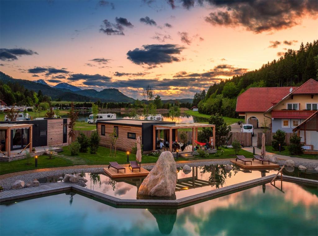 an aerial view of a house with a pool at Lakeside Petzen Glamping in Unterlibitsch