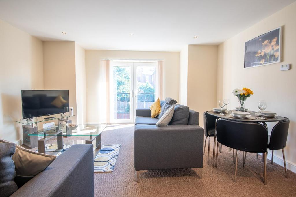 a living room with a couch and a table at Apartment 11 in Worksop