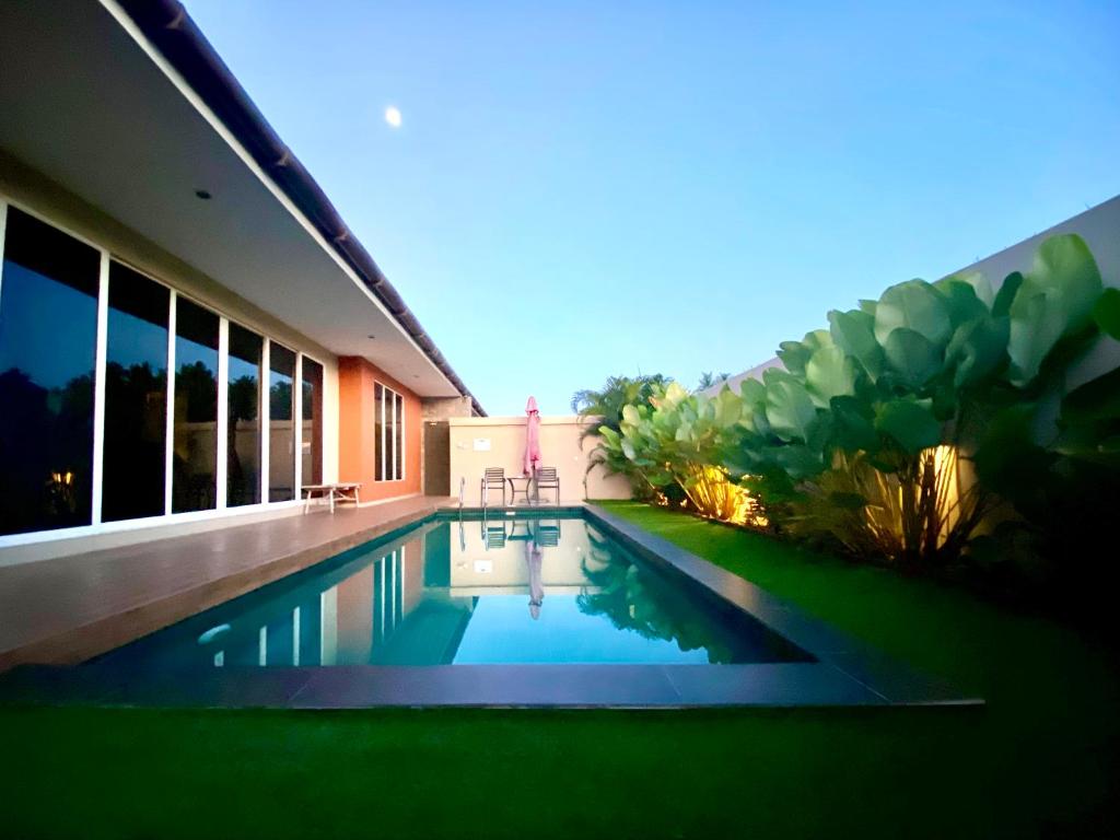 a swimming pool in the backyard of a house at The Paddy Field - Private Pool Villas in Pantai Cenang