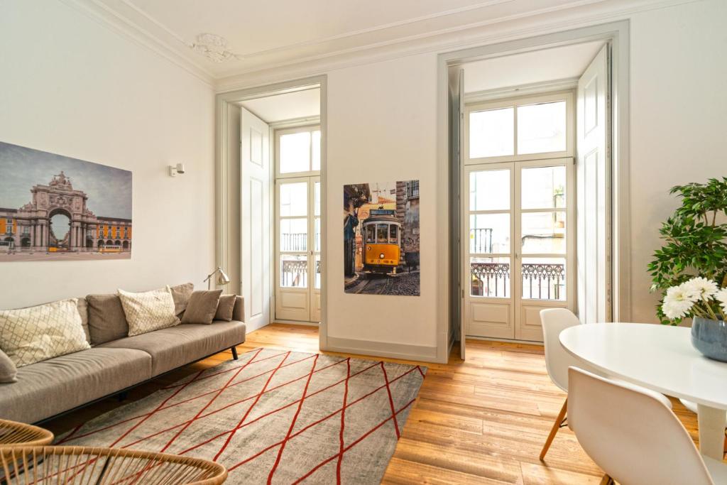 a living room with a couch and a table at Baixa Charming Apartment in Lisbon