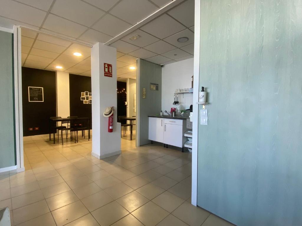 a hallway with a kitchen and a dining room at NC Hostel in Las Palmas de Gran Canaria