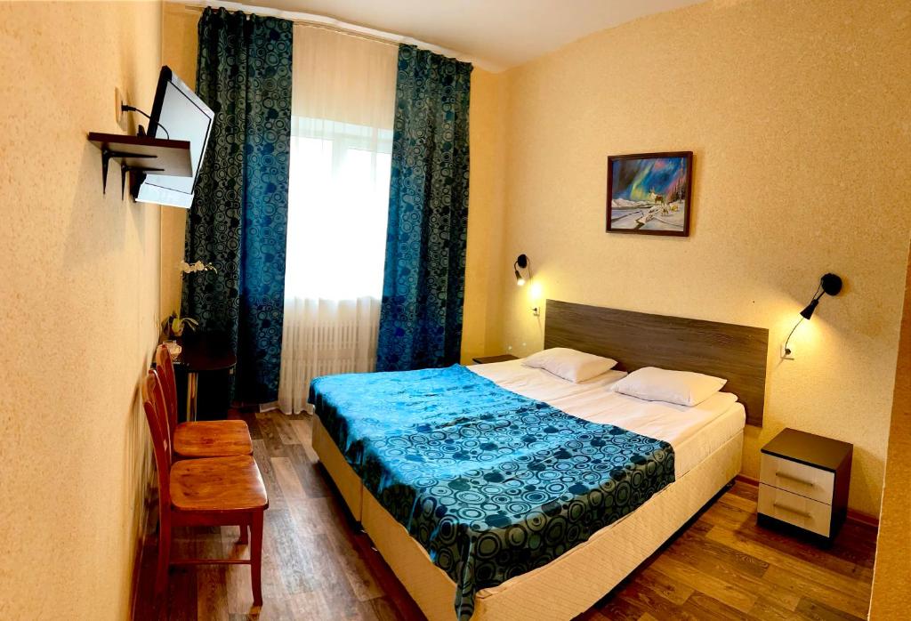 a hotel room with a bed and a window at Hotel Nord in Voronezh