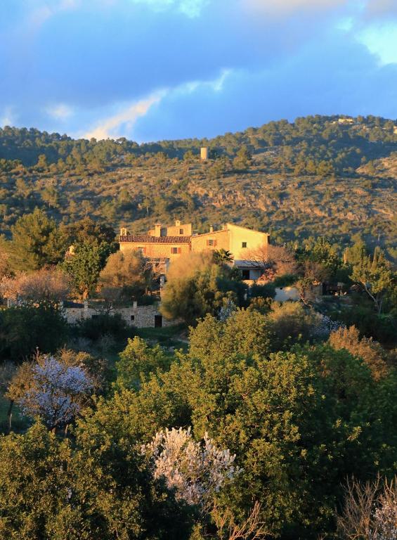 a house on a hill with a rainbow in the background at Son Malero in Calvia Town
