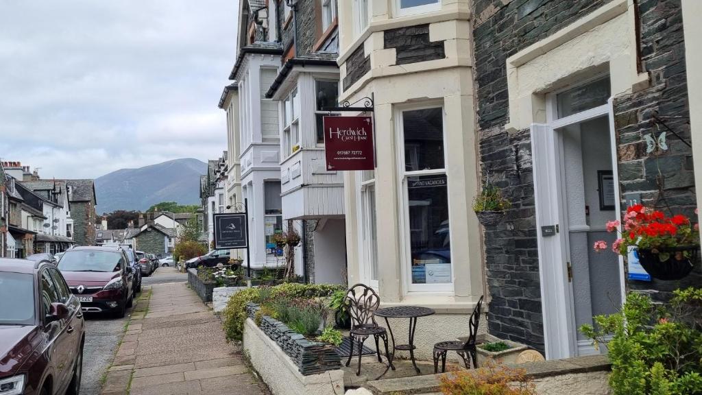 a street in a small town with a table and chairs at Herdwick Guest House in Keswick
