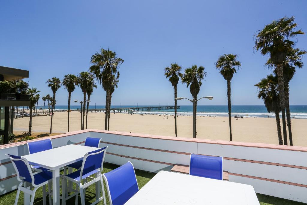 a patio with tables and chairs and the beach at Venice on the Beach Hotel in Los Angeles