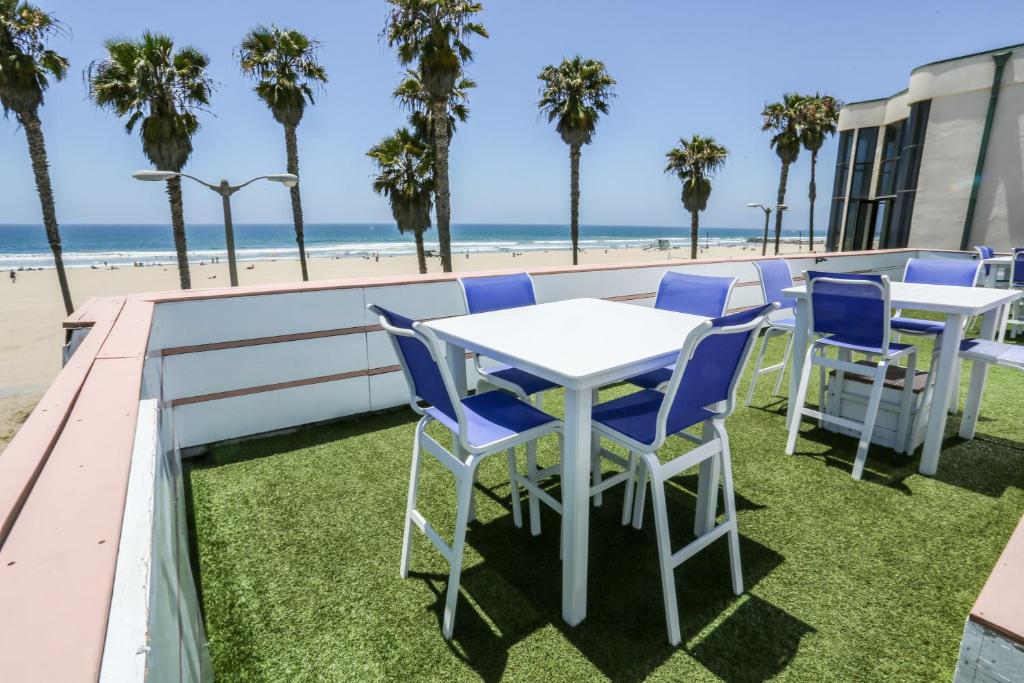 a table and chairs on a balcony with the beach at Venice on the Beach Hotel in Los Angeles