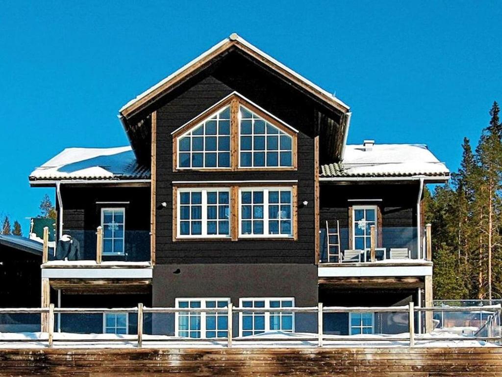 a large black house with snow on the roof at 8 person holiday home in VEMDALEN in Vemdalen