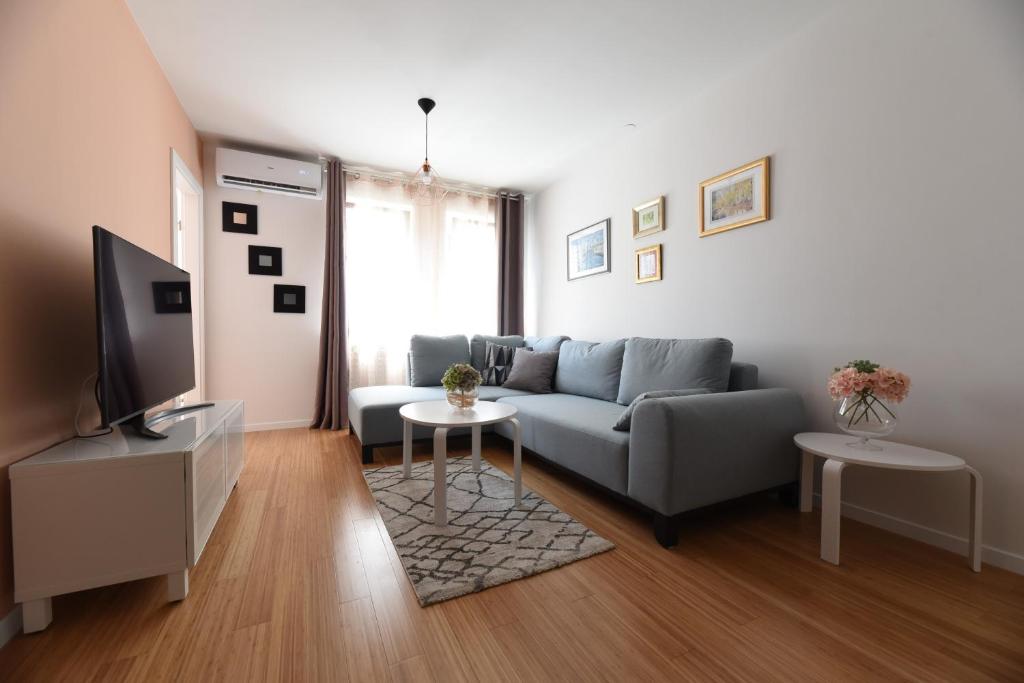 a living room with a couch and a tv at Mary's apartment - with free parking in Zagreb