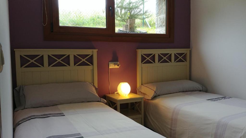 A bed or beds in a room at La Calma de Llanes