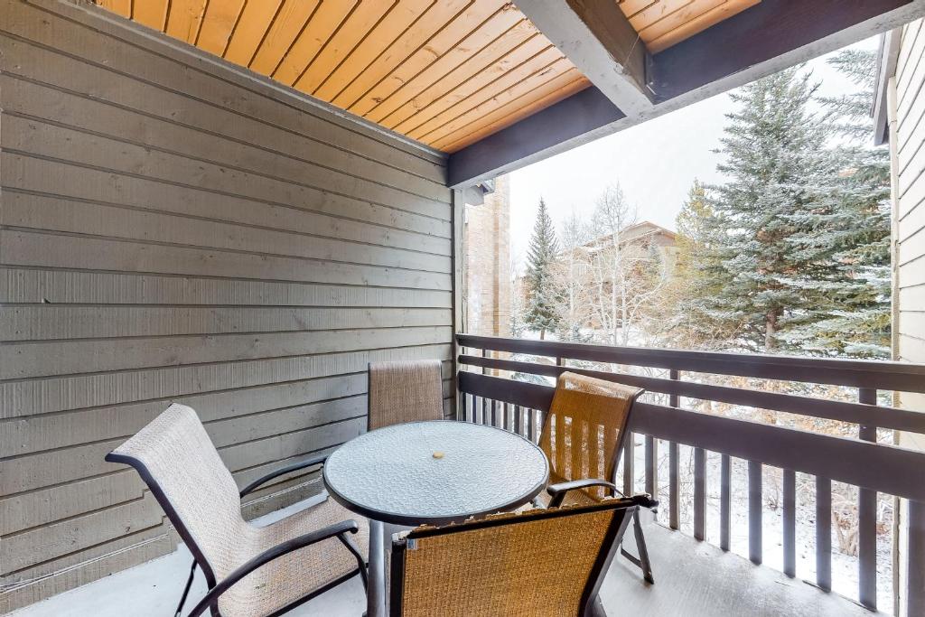 a patio with a table and chairs on a balcony at Lodge at Steamboat B303 in Steamboat Springs