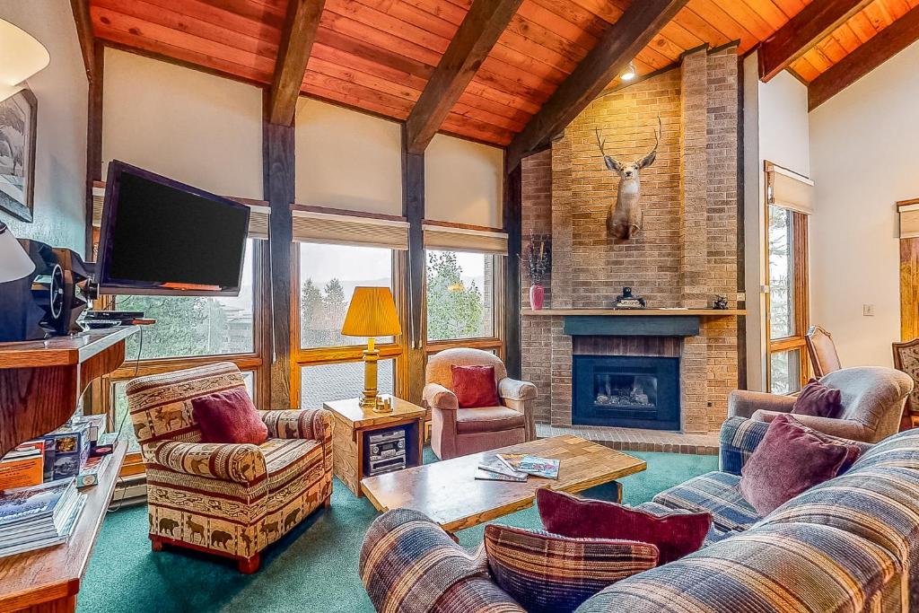 a living room with a couch and a fireplace at Lodge at Steamboat C301 in Steamboat Springs