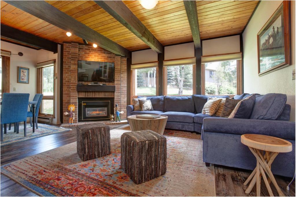 a living room with a blue couch and a fireplace at Lodge at Steamboat B105 in Steamboat Springs