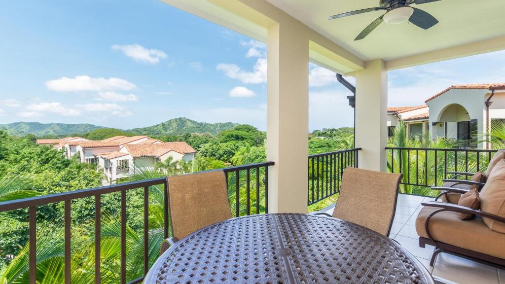 a patio with a table and chairs on a balcony at Well-decorated 3rd-floor unit with unique designs and mountain view in Coco in Coco