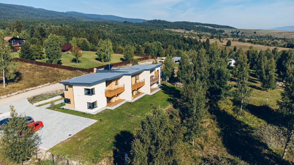 an aerial view of a house in the mountains at Bazalt Apartments in Miercurea-Ciuc