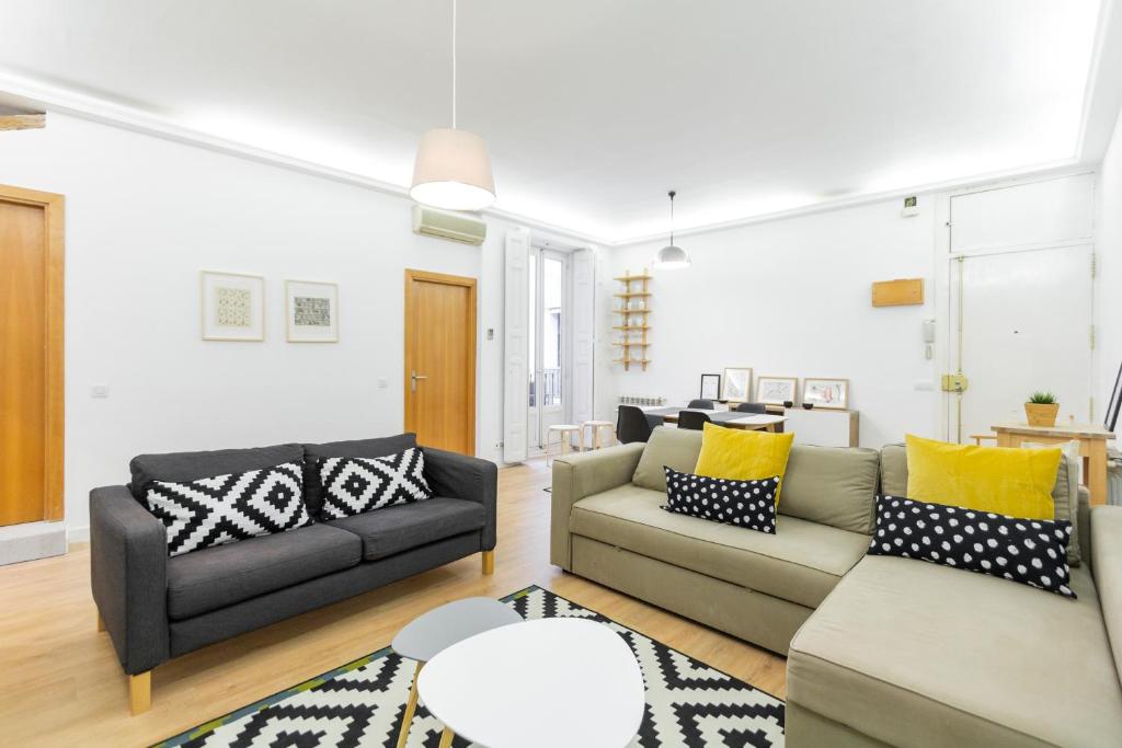 a living room with two couches and a table at dobohomes - Zurbano in Madrid