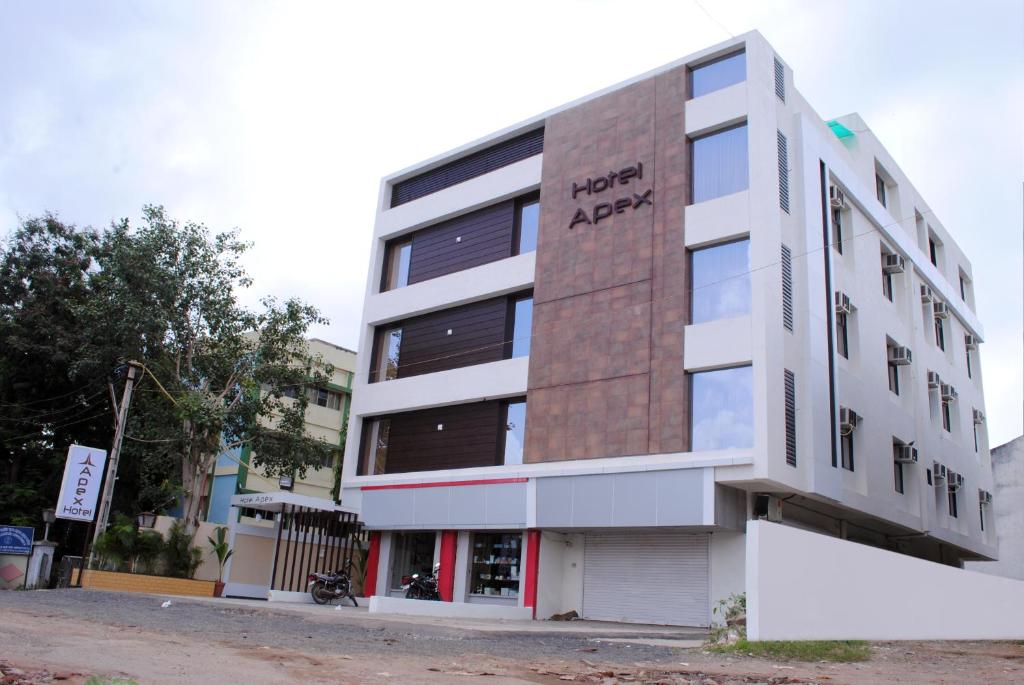 an apartment building with the words happy apex on it at Hotel New Apex in Ankleshwar