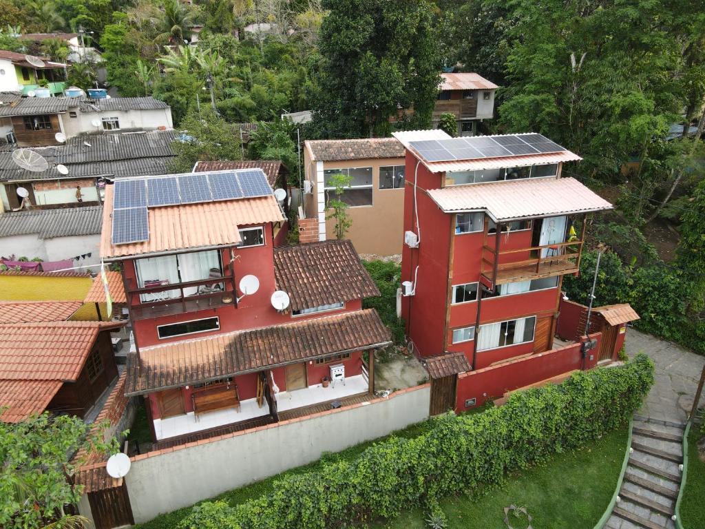 an aerial view of a house with solar panels on it at Mi Casa Su Casa Lofts in Abraão