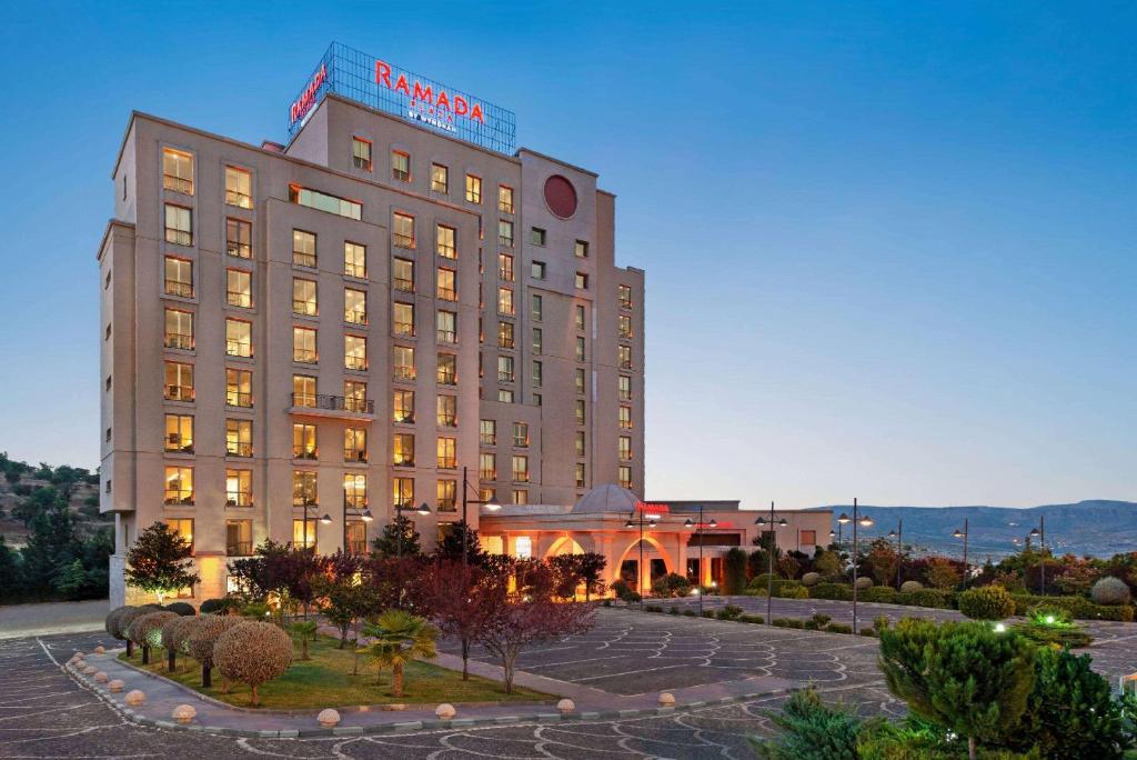 a hotel building with a sign on top of it at Ramada Plaza by Wyndham Mardin in Mardin