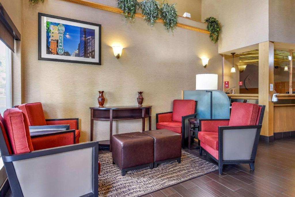 a waiting room with colorful chairs and a table at Comfort Suites Portland Airport in Portland