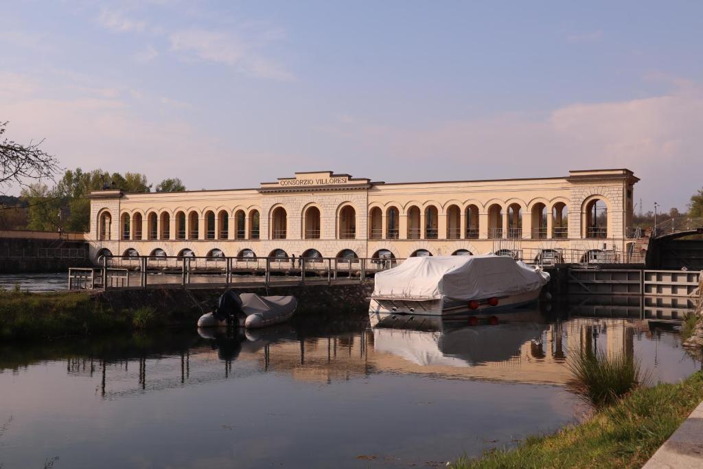 a large building next to a river with boats in it at Panperduto in Somma Lombardo