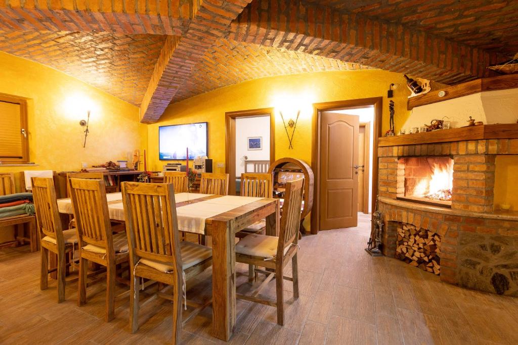 a dining room with a table and a fireplace at Apartma Zgodba in Cerklje na Gorenjskem
