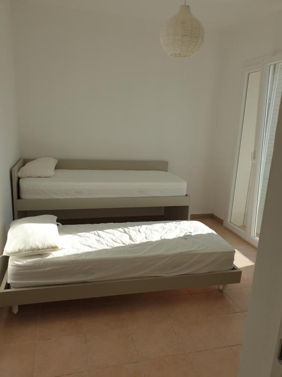 Łóżko lub łóżka w pokoju w obiekcie Villa Orietta