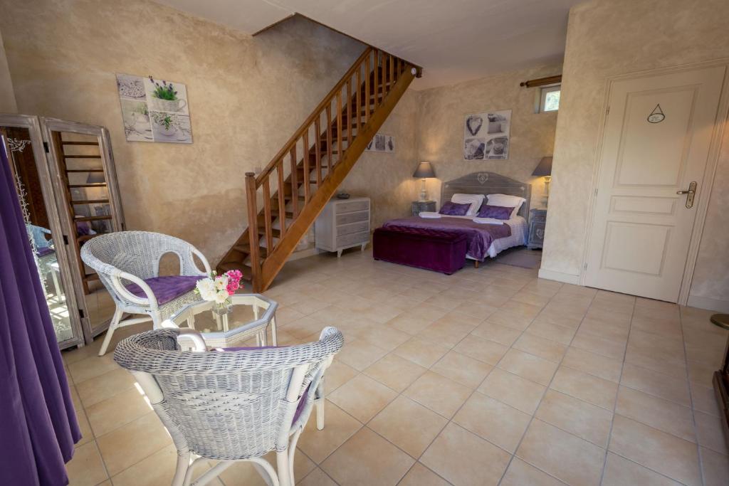 a room with a staircase and a bed and a bedroom at Gites Le Clos de Saires in Saires