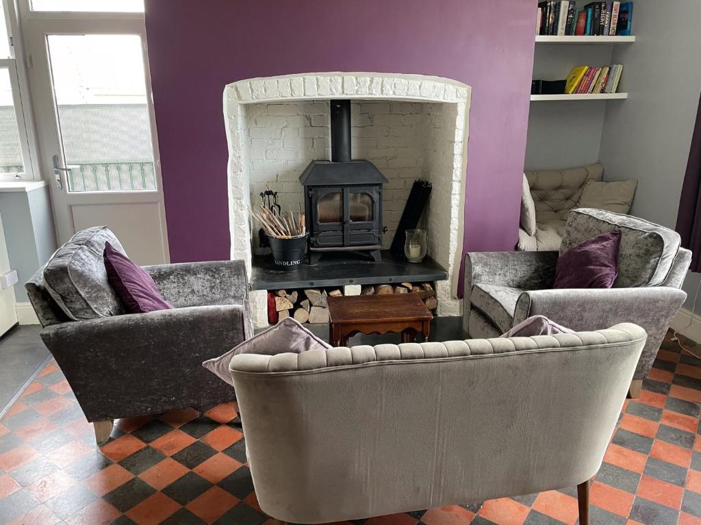 a living room with two chairs and a fireplace at Hilltop in Llandeilo