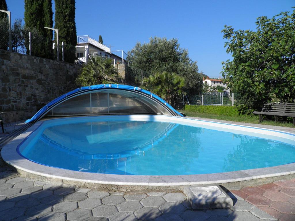 a large blue swimming pool in a yard at Apartments Cipresa in Portorož