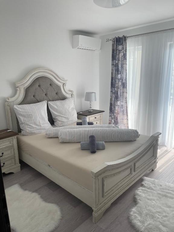 a bedroom with a large bed with a large headboard at Smiley Deluxe in Sibiu