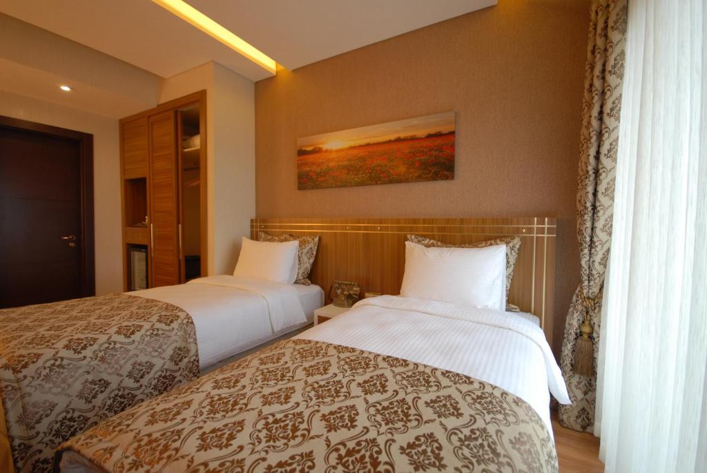 Postel nebo postele na pokoji v ubytování Imamoglu Pasa Butik Hotel