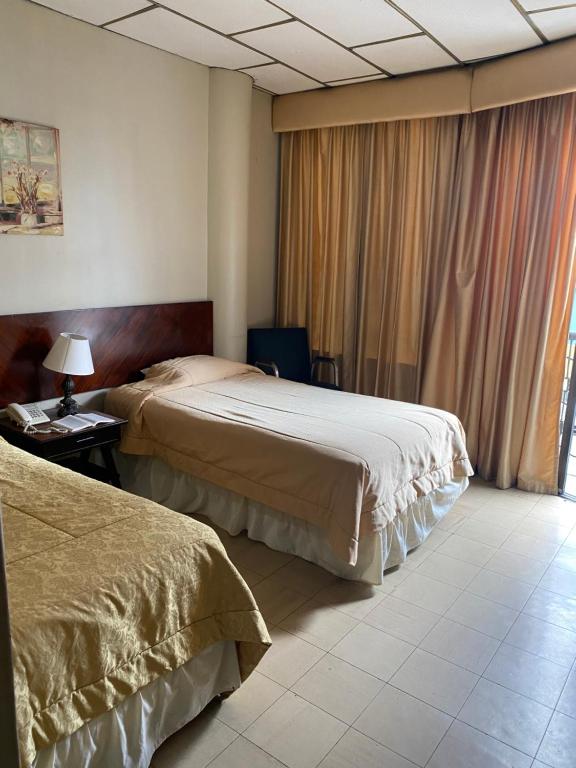 Postel nebo postele na pokoji v ubytování Hotel Rizzo