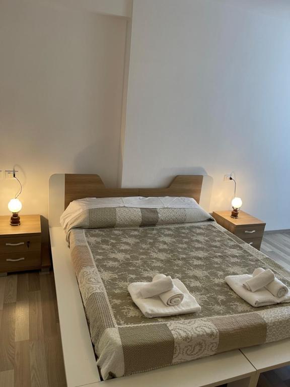 a bedroom with a bed with two towels on it at Holiday Apartment in Vlore in Vlorë