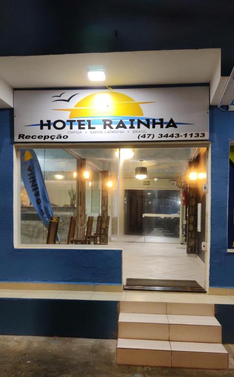 a hotel refridgerator with a surfboard in the window at Hotel Rainha in Itapoa