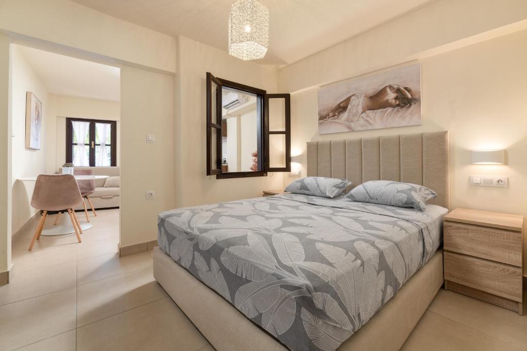 a bedroom with a bed and a living room at To Rodi Apartments in Rhodes Town