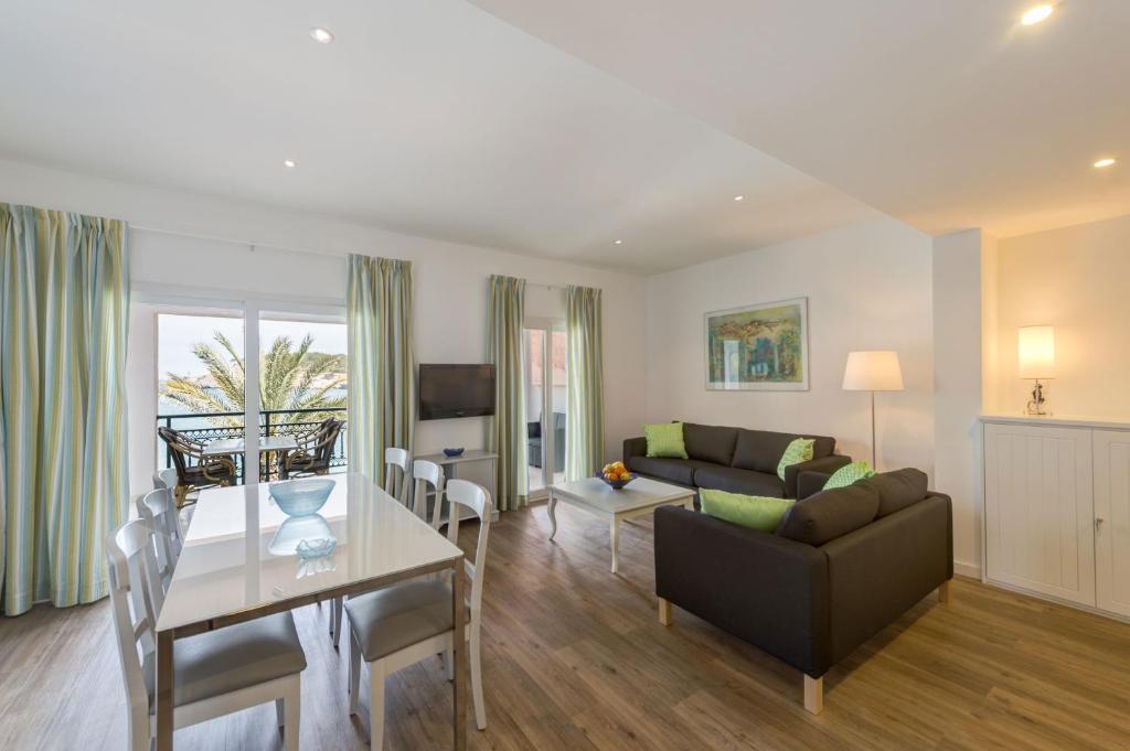 a living room with a couch and a table at Lili Apartments in Port de Soller