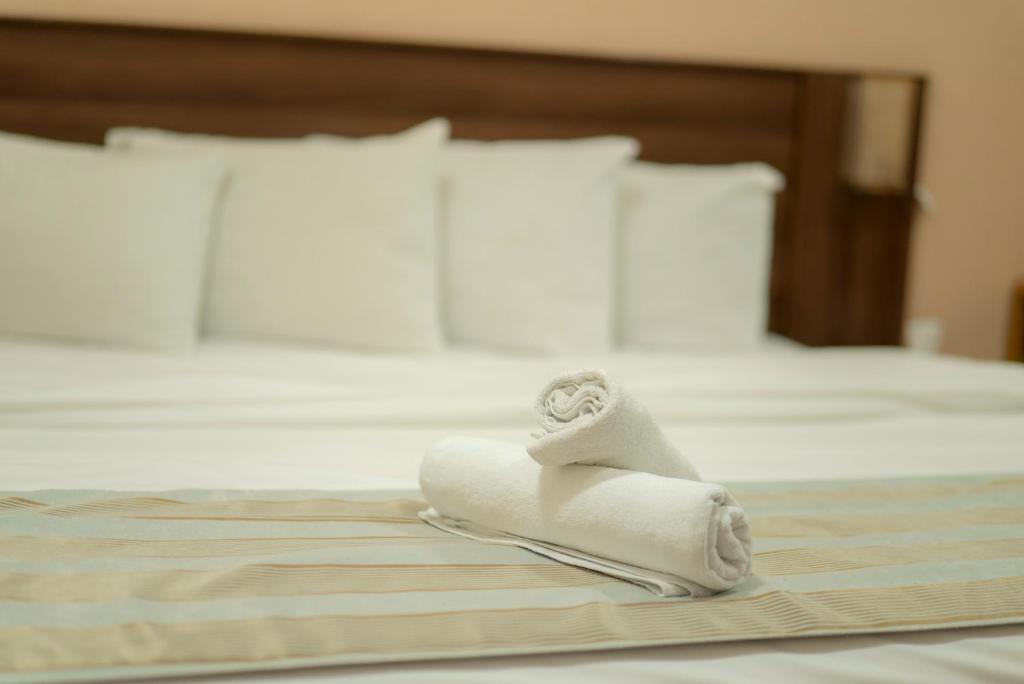 Postel nebo postele na pokoji v ubytování Al Ghubrah Plaza Hotel