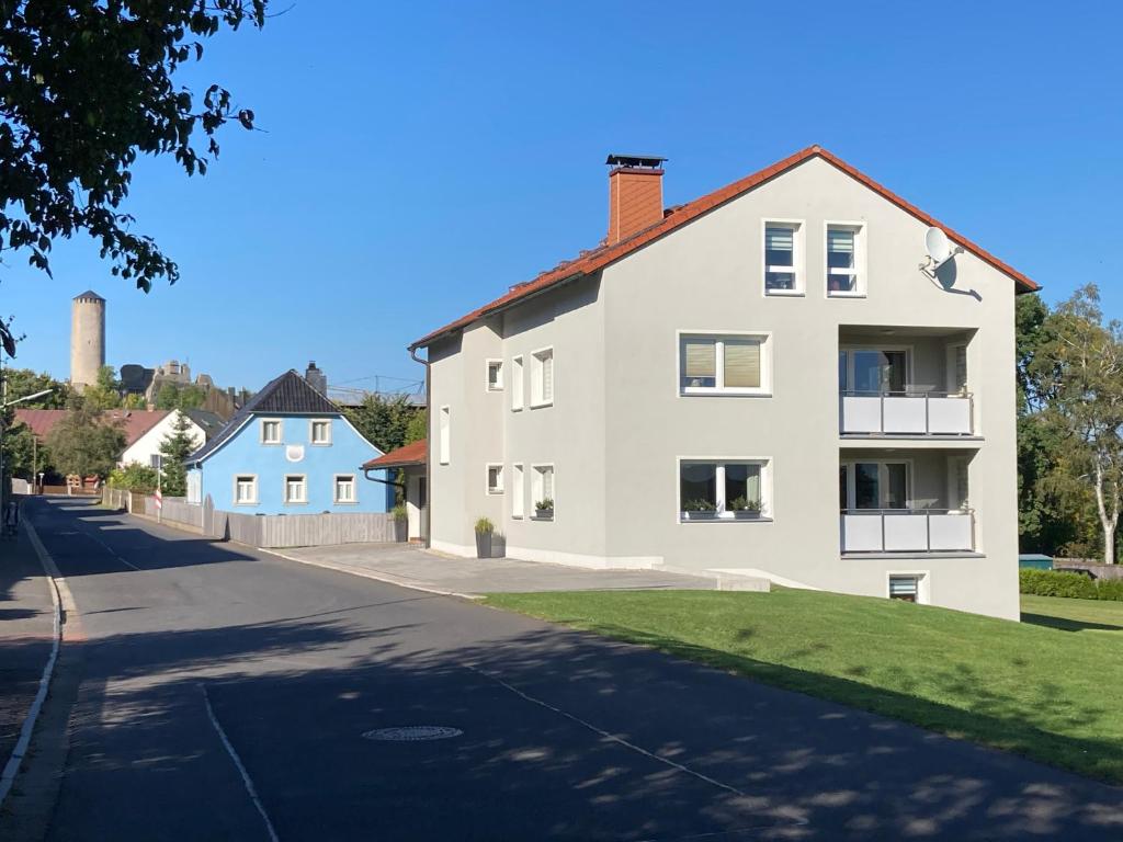 a white house on the side of a street at Feriendomizil Fichtelherz in Thierstein