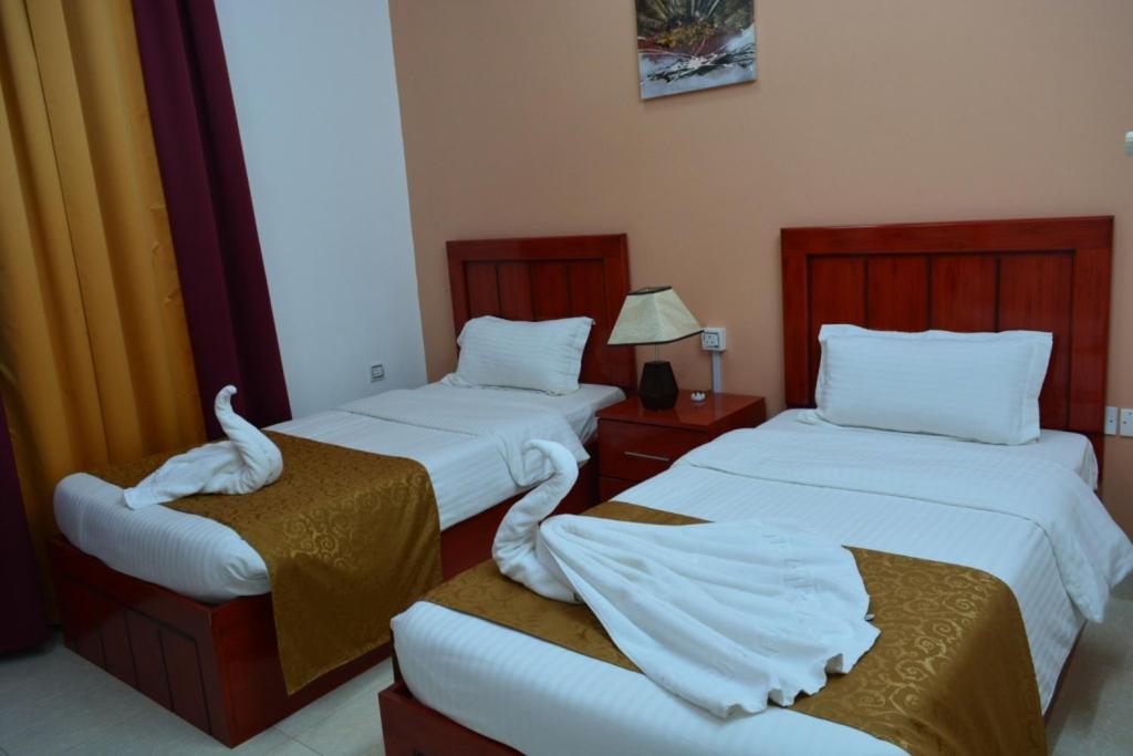 Postel nebo postele na pokoji v ubytování Al Karam Hotel Apartment