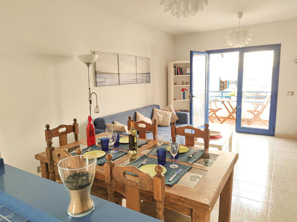 a living room with a dining room table and a couch at VolKKanrentals Casa Machín in Famara