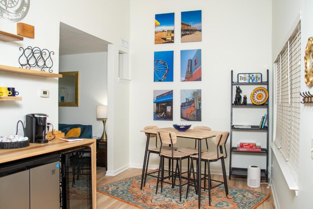 a kitchen and dining room with a table and stools at True North - A Beach & Boat Lover's Dream in Carolina Beach