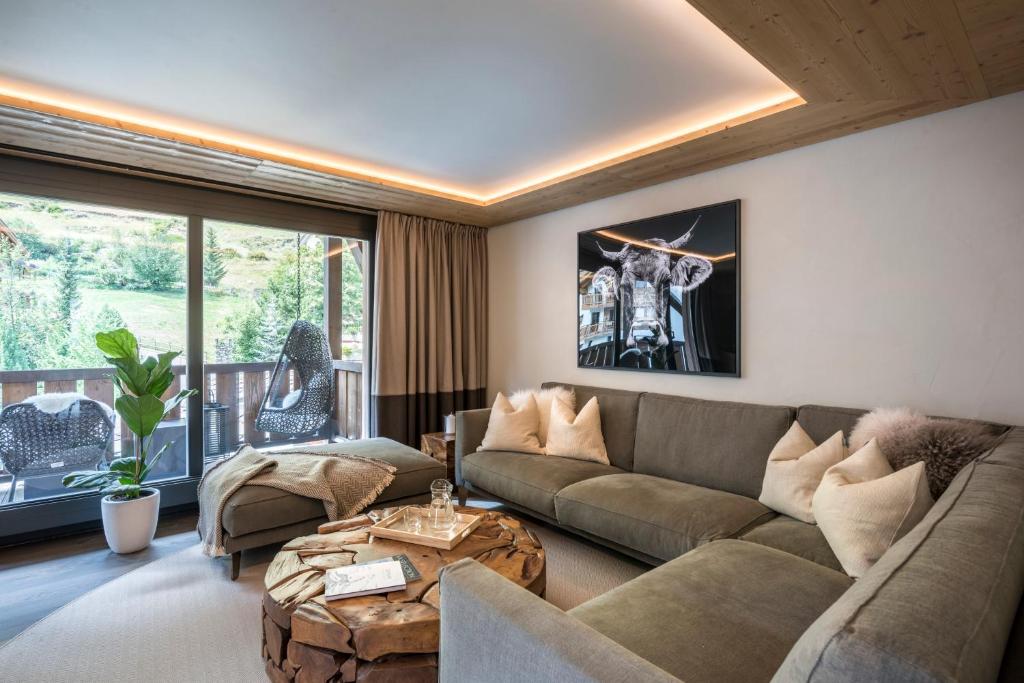 een woonkamer met een bank en een tafel bij Nevada Duplex Apartment in Zermatt