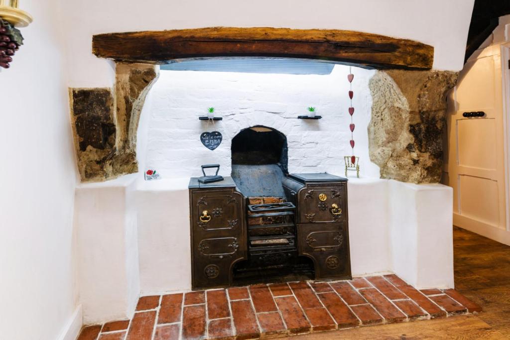 an oven in a room with a brick floor at "Wesley House" Historic home in town Centre with Parking in Shrewsbury