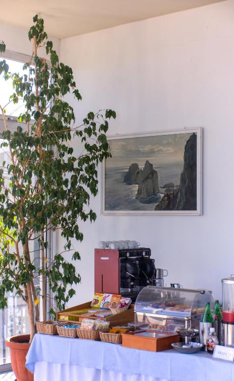 a kitchen with a table with a picture on the wall at Hotel Bellavista in Anacapri
