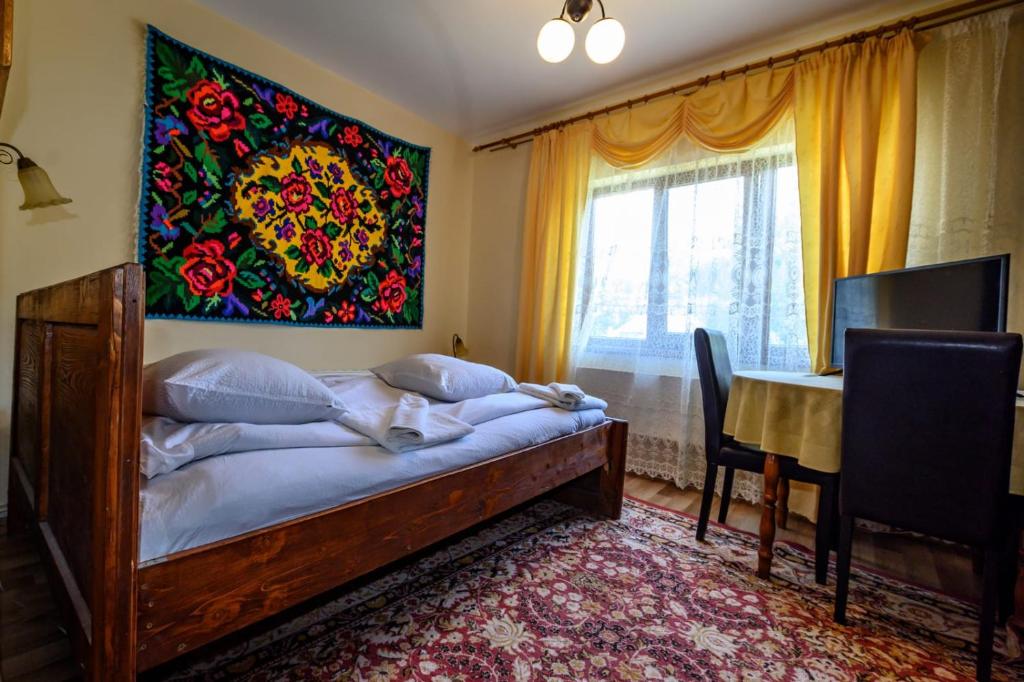 Postel nebo postele na pokoji v ubytování Pensiunea Denisa